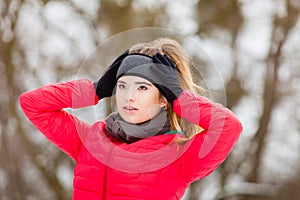 Woman wearing warm sportswear getting ready before exercising