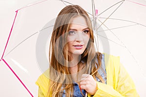 Woman wearing waterproof coat holding umbrella