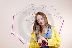 Woman wearing waterproof coat holding umbrella