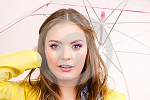 Woman wearing waterproof coat holding umbrella