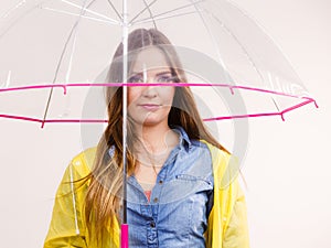 Woman wearing waterproof coat holding umbrella