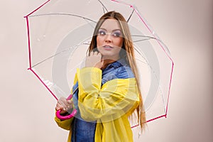Woman wearing waterproof coat holding umbrella