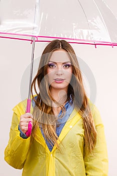 Woman wearing waterproof coat holding umbrella