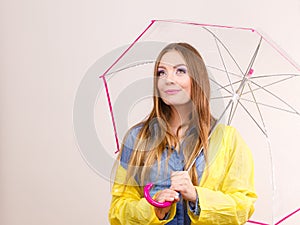 Woman wearing waterproof coat holding umbrella