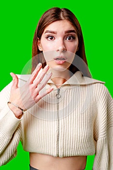 A woman wearing a white sweater is gesturing with her hand, possibly expressing emotion or emphasizing a point.