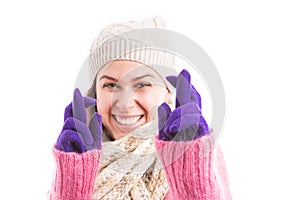 Woman wearing winter clothes making good luck gesture