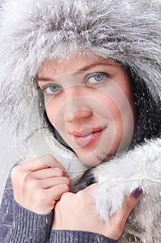 Woman wearing winter gloves covered with snow flakes