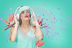 A woman wears headphones, surrounded by vibrant splashes of paint and bird of paradise flowers, evoking a sense of dynamic music