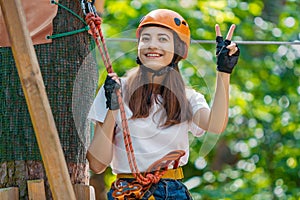 Woman wears protective helmet enjoy active leisure in rope park