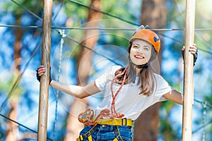 Woman wears protective helmet enjoy active leisure in rope park