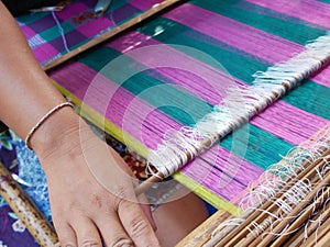 Woman weaving cloth in traditional style