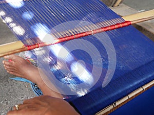 Woman weaving cloth in traditional style