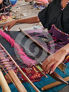 Woman weaving cloth in traditional style