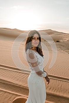 A woman in a wedding dress in the desert