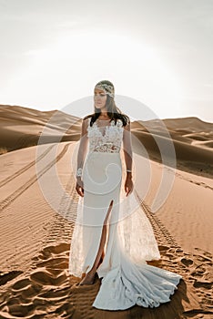 A woman in a wedding dress in the desert