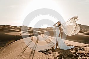 A woman in a wedding dress in the desert