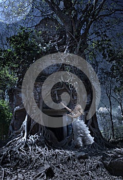 The woman in a wedding dress worships to the Moon at an entrance to the thrown temple, night, Cambodia photo