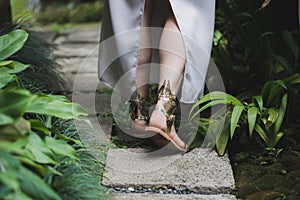 Woman wedding shoes golden colored with angel`s wings