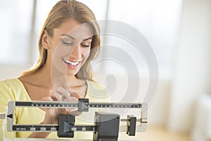 Woman Weighing Herself On Balance Scale