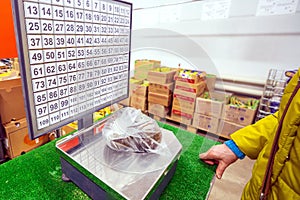 Woman weighs apples at the grocery store