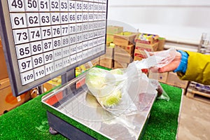 Woman weighs apples at the grocery store