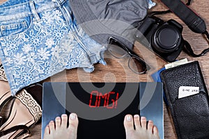 Woman weighs herself before vacation. Concept of unhealthy lifestyle and weight control. photo