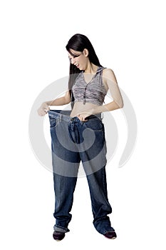 Woman after weight-loss trying her old jeans