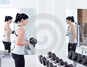 Woman with weight training equipment on sport gym photo