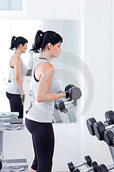 Woman with weight training equipment on sport gym