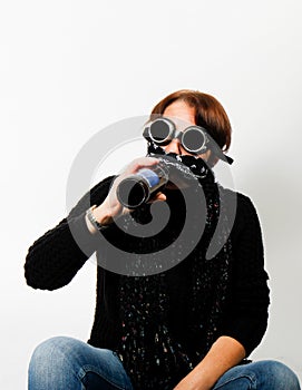 Woman with welding goggles drinking beer