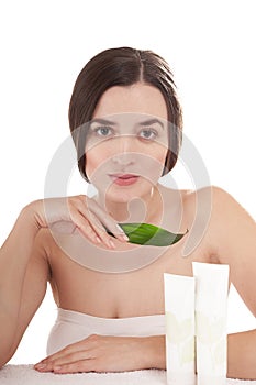 Woman with well-groomed skin near organic cosmetics.