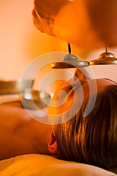 Woman at Wellness massage with singing bowls