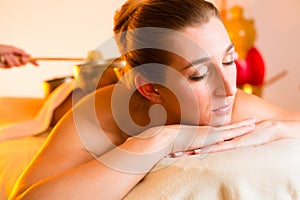 Woman at Wellness massage with singing bowls