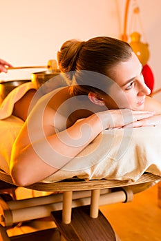 Woman at Wellness massage with singing bowls