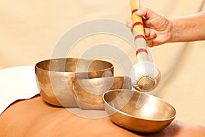 Woman and Wellness with singing bowls