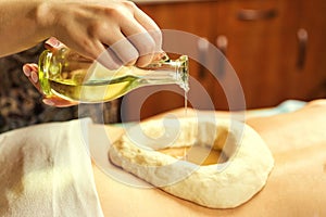 woman in wellness spa having aroma therapy massage with essential oil,Woman enjoying a Ayurveda oil massage treatment in