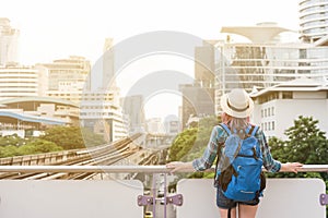 Woman westerner admiring the view of city in morning, Travelling