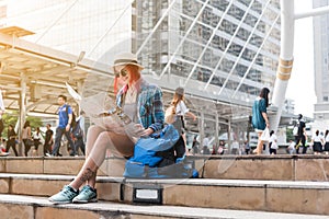 Woman westerner looking at map during city tour in the morning,