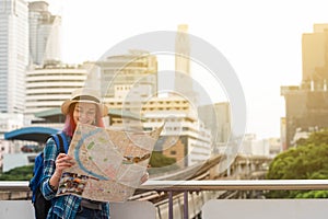 Woman westerner looking at map during city tour in the morning,