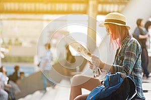 Woman westerner looking at map during city tour in the morning,