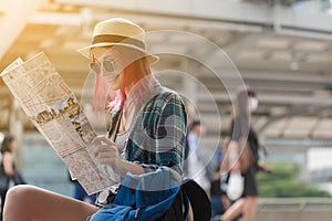 Woman westerner looking at map during city tour in the morning,