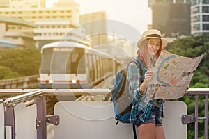 Woman westerner looking at map during city tour in the morning, photo