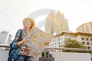 Woman westerner looking at map during city tour in the morning, photo