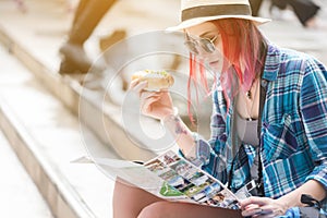 Woman westerner looking at map and smartphone during breakfast w photo