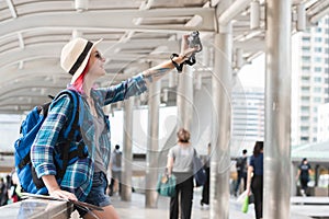 Woman westerner taking selfie during travel in city happy moment