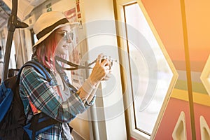 Woman westerner write admire view from train`s window and take p