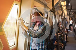 Woman westerner write admire view from train`s window and take p