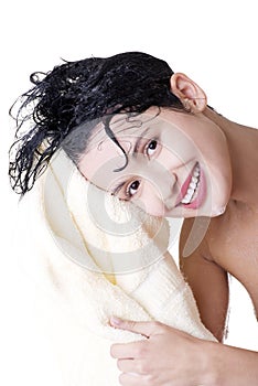 Woman with wet hair in white robe toweling off.