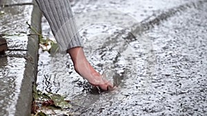 Woman wets his hand in the stream