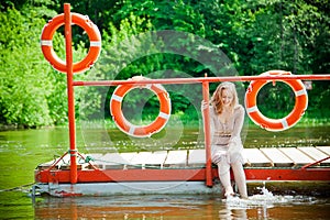 Woman wetting her feet in the river